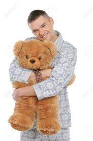 Man With Teddy Bear. Young Man In Pajamas Hugging Teddy Bear And Smiling  While Standing Isolated On White Stock Photo, Picture and Royalty Free  Image. Image 21986098.