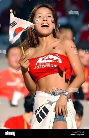 dpa-a-female-south-korean-soccer-fan-waves-a-flag-while-watching-her-D3A4PJ.jpg