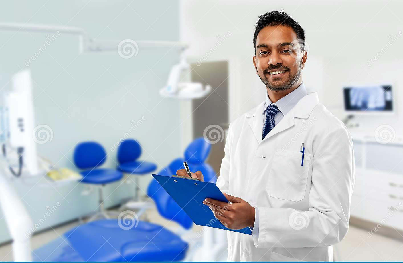 indian-dentist-clipboard-over-dental-clinic-medicine-dentistry-healthcare-concept-smiling-male...jpg